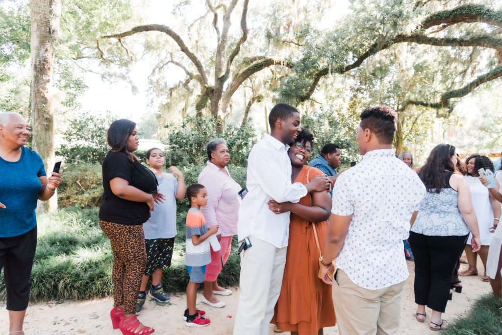 celebrating with family after the Washington Oaks Garden State Park surprise proposal Photo by Black Tie & Co. (www.btcweddings.com)