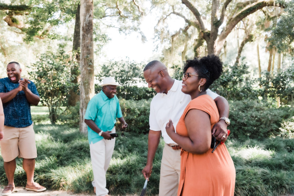 celebrating with family after the Washington Oaks Garden State Park surprise proposal Photo by Black Tie & Co. (www.btcweddings.com)