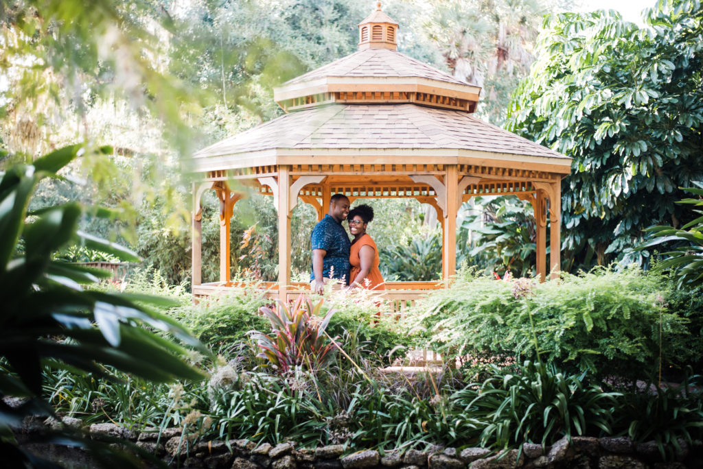 couple under the gazebo mini engagement session at Washington Oaks Garden State Park after surprise proposal Photo by Black Tie & Co. (www.btcweddings.com)