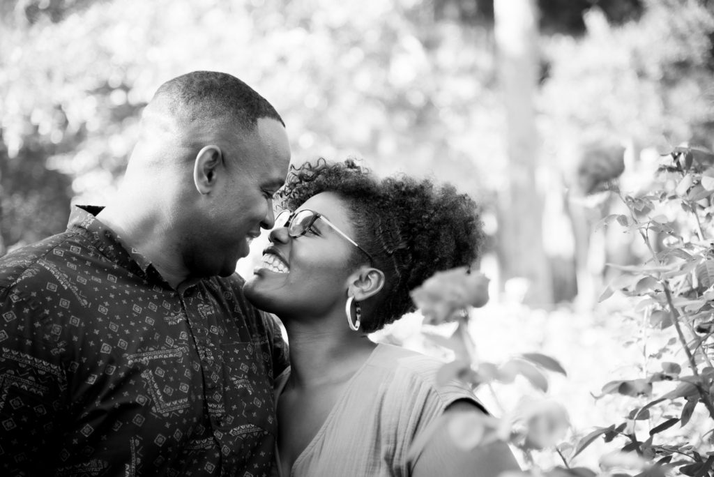 couple laughing engagement session at Washington Oaks Garden State Park after surprise proposal Photo by Black Tie & Co. (www.btcweddings.com)