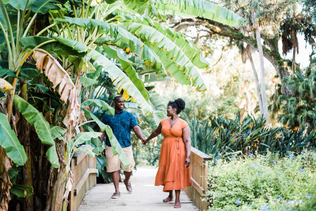 beautiful engagement photos on bridge at Washington Oaks Garden State Park after surprise proposal Photo by Black Tie & Co. (www.btcweddings.com)