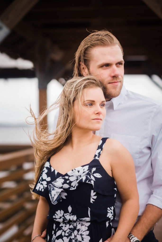 Close up of couple taking engagement photo the dock of the St Johns River at the   Alpine Groves Park. in Jacksonville Florida  Photo By Black Tie & Co. www.btcweddings.com