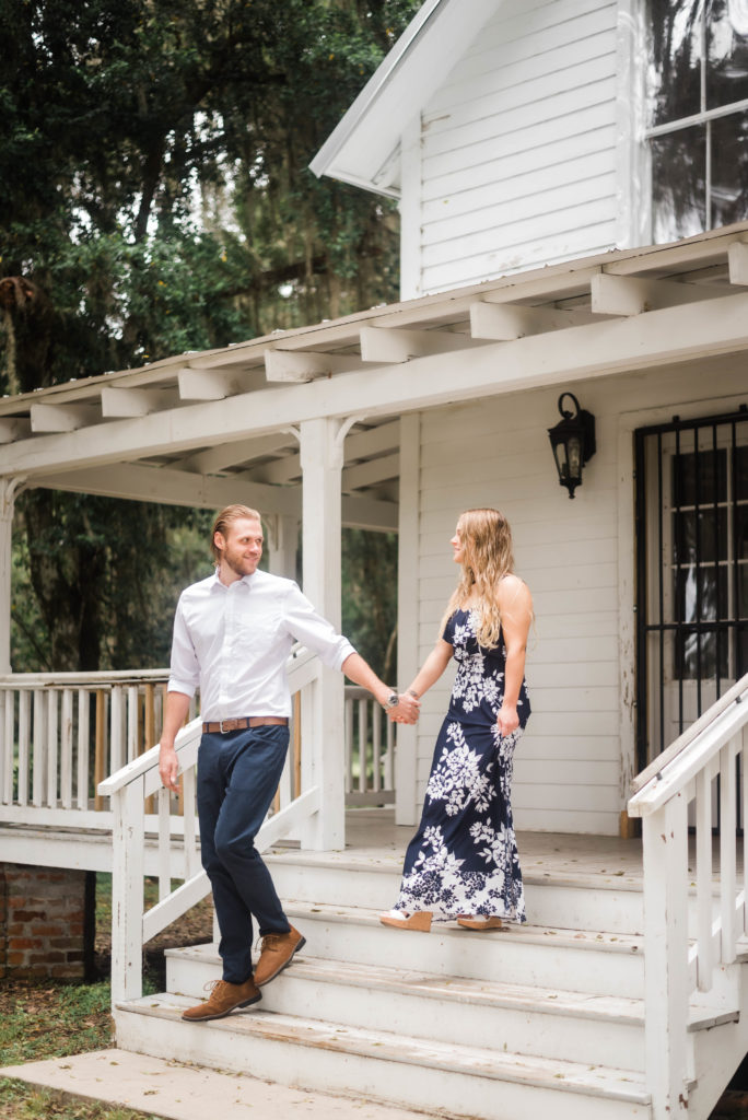 Engagement photos in front of the Bennett House, couple walking down the steps, Alpine Groves Park. Photo By Black Tie & Co. www.btcweddings.com