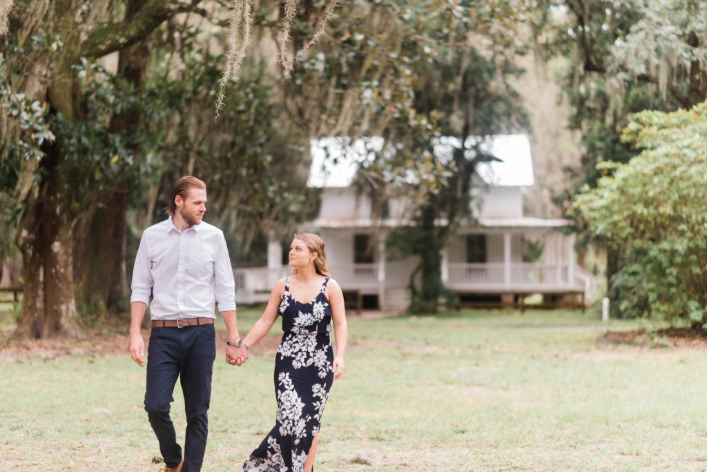 couple walking away from the Bennett House engagement photo,  Alpine Groves Park. in Jacksonville Florida  Photo By Black Tie & Co. www.btcweddings.com