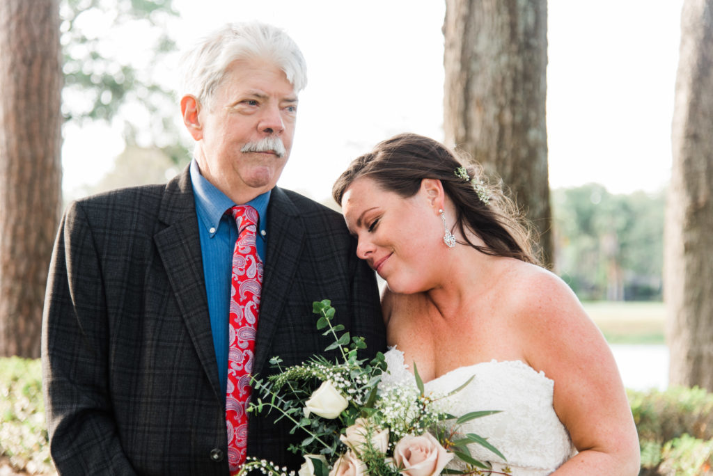 bride gives father a hug Queen's Harbour country club in Jacksonville Florida Photography by Chabeli Woolsey Black Tie & Co www.btcweddings.com