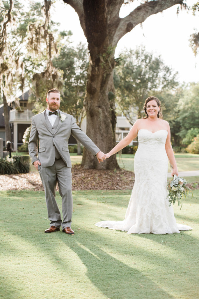 bride and groom take photos during their wedding Queen's Harbour country club in Jacksonville Florida Photography by Chabeli Woolsey Black Tie & Co www.btcweddings.com