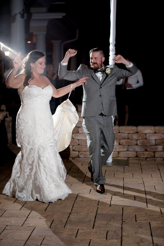 Bride and Groom introduced at their reception in the courtyard at the Queen's Harbour country club in Jacksonville Florida Photography by Chabeli Woolsey Black Tie & Co www.btcweddings.com