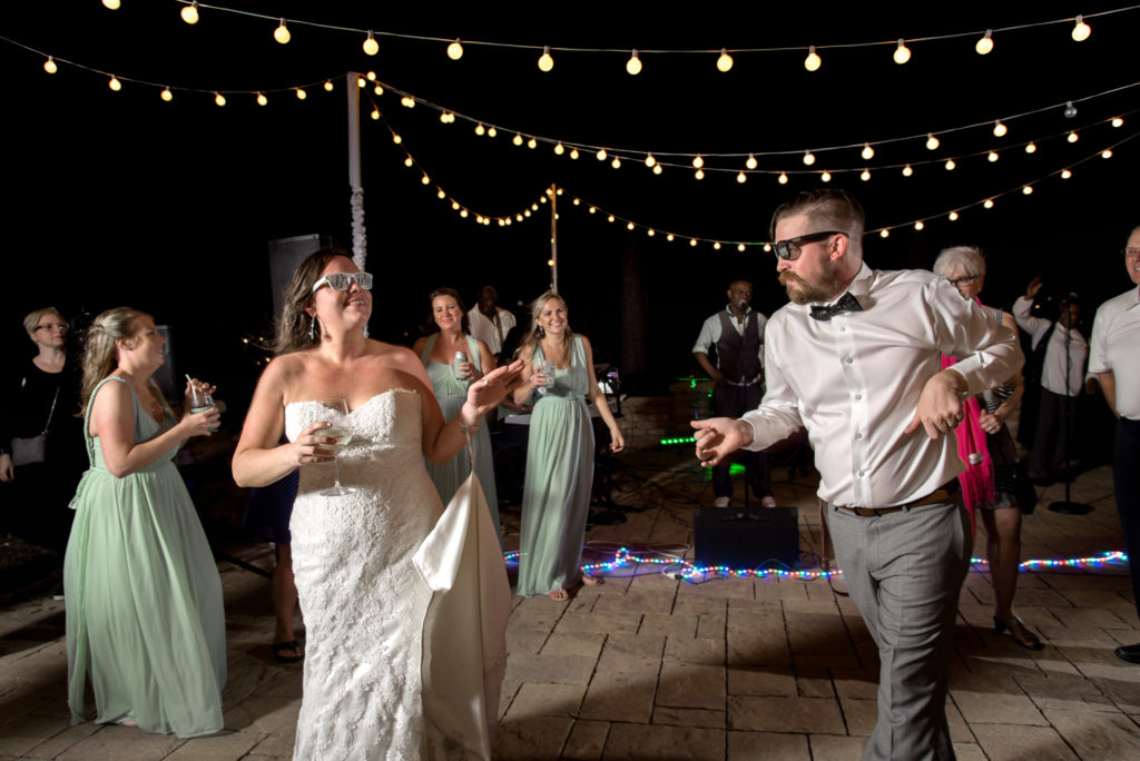 bridegroom celebrating during wedding reception Queen's Harbour country club in Jacksonville Florida Photography by Chabeli Woolsey Black Tie & Co www.btcweddings.com